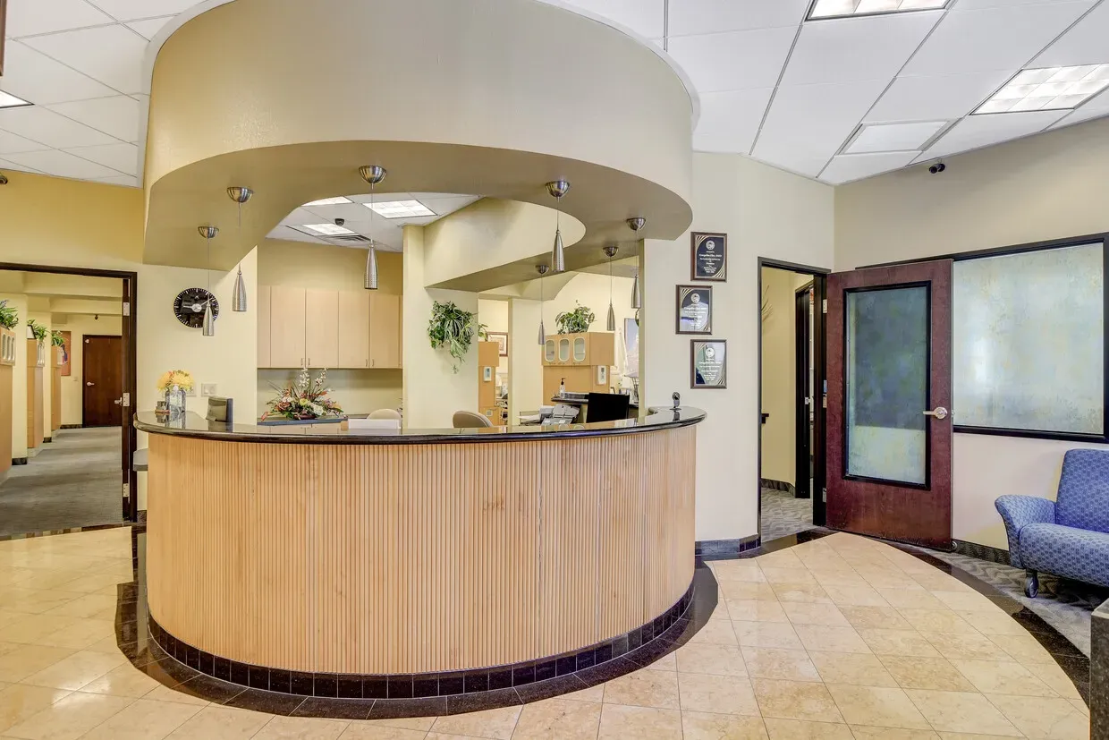 Curved wooden reception desk in the Greater Las Vegas Dental lobby